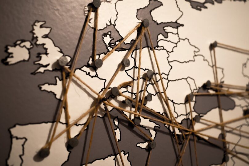 Map of Europe with pins connected by string