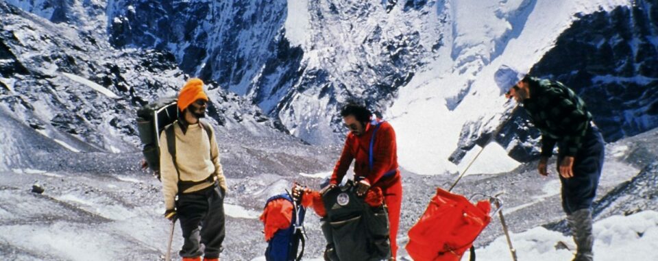 Three mountaineers stood on a snowy mountain