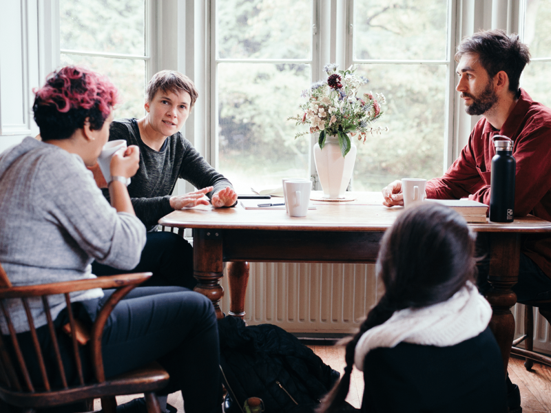 Participants at a JB residential talking to one another