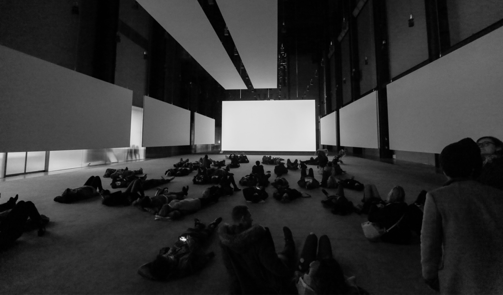 Audience lying on the floor to experience an artwork at the Tate Gallery