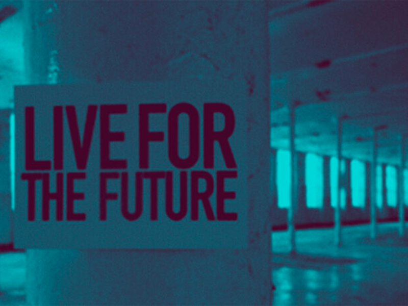 Blue tinted picture with sign on a pillar saying 'Live for the future'