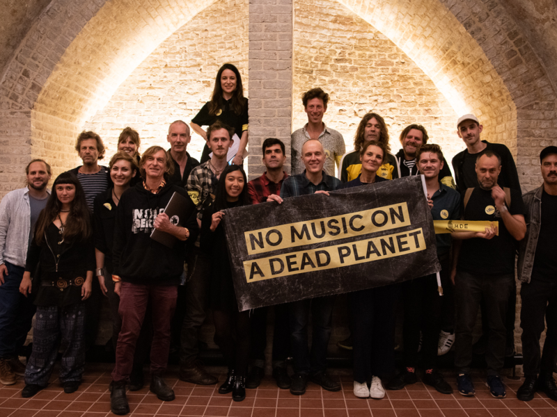 MDE organising group gather with a banner saying 'No Music on a Dead Planet'