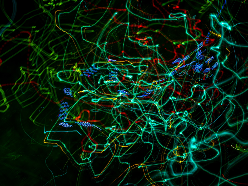 swirly patterns in green and blue on a black background