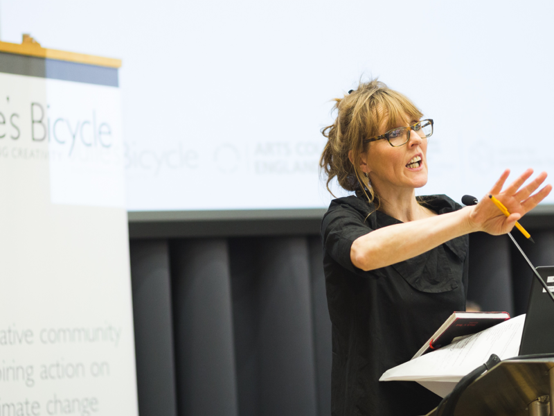 Alison Tickell gesticulating whilst presenting from a podium