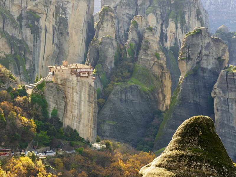 small building on a hill in a beautiful mountain range