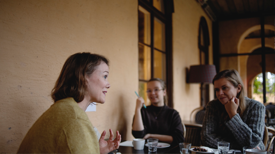 Three people in conversation