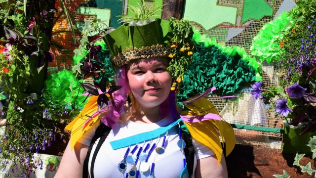 Person wearing colourful mardi gras costume