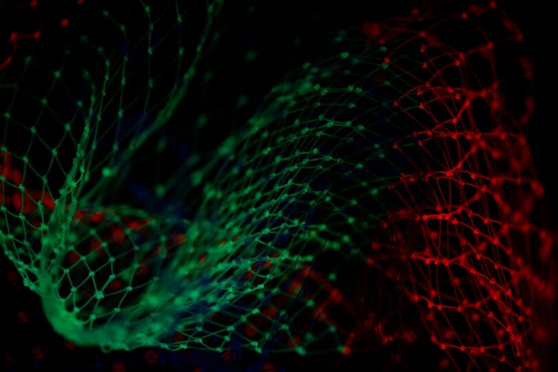 An image of green and red luminous data waves