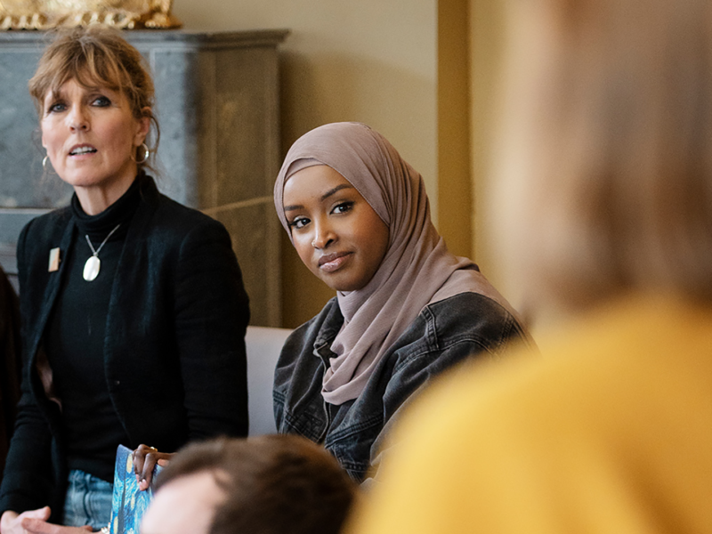 Two people intently listening to a speaker