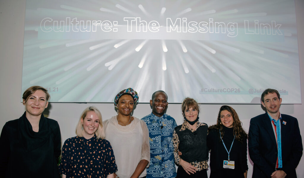 Seven people in front of a presentation: Culture: The Missing Link