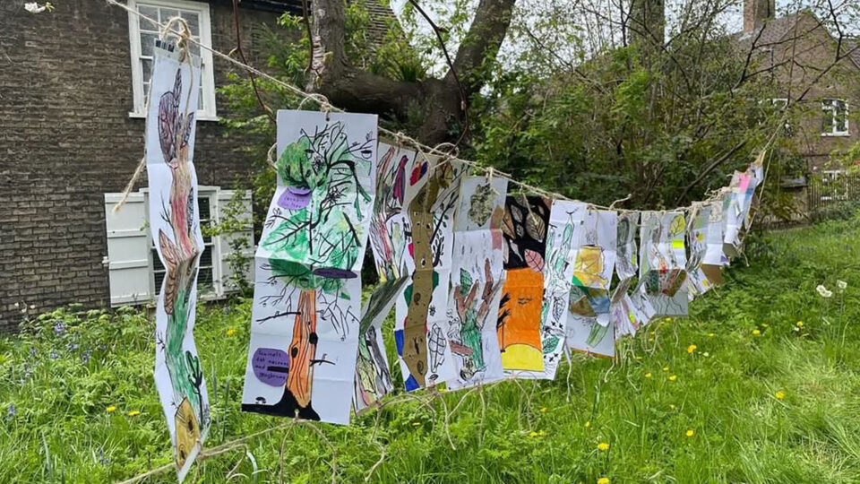 Collages hanging on a clothesline outside