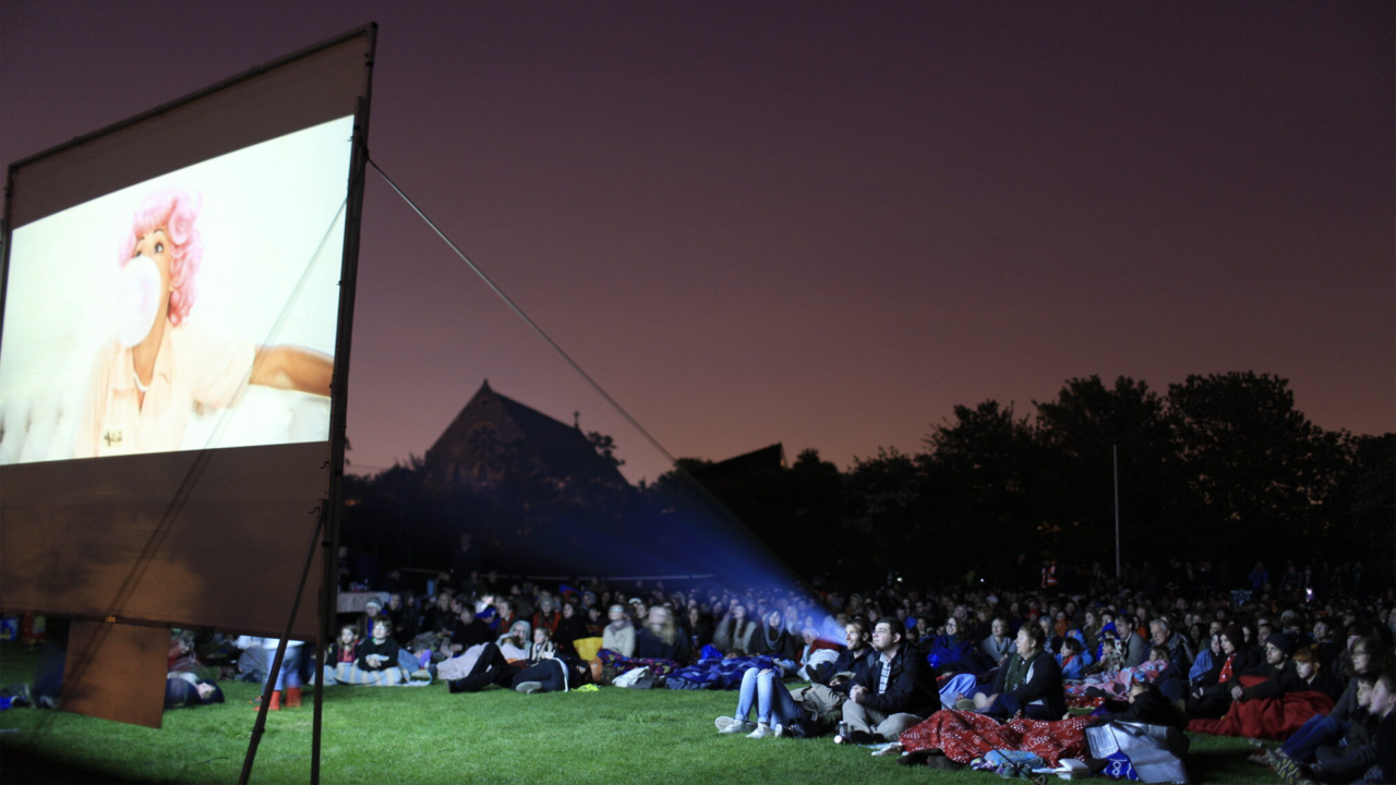 People at an outdoor cinema watching Grease (1978)