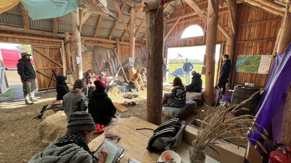 A group of people gathered in a barn