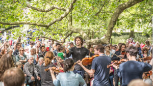 Busy forest performance with audience and musicians