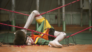 Person doing contortion around a boxing rink