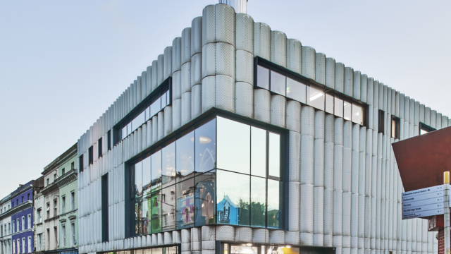 Landscape shot of Creative Folkestone building in Kent, grey with corrugated design and glass windows.