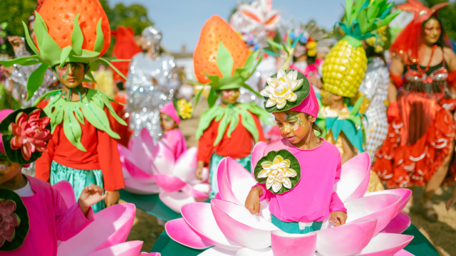 Colourful festival with people in flower costumes