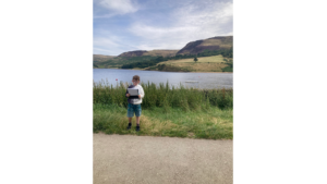 Kid outside overlooking reservoir