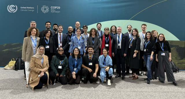 Alison Tickell stands alongside a group of other delegates at COP29