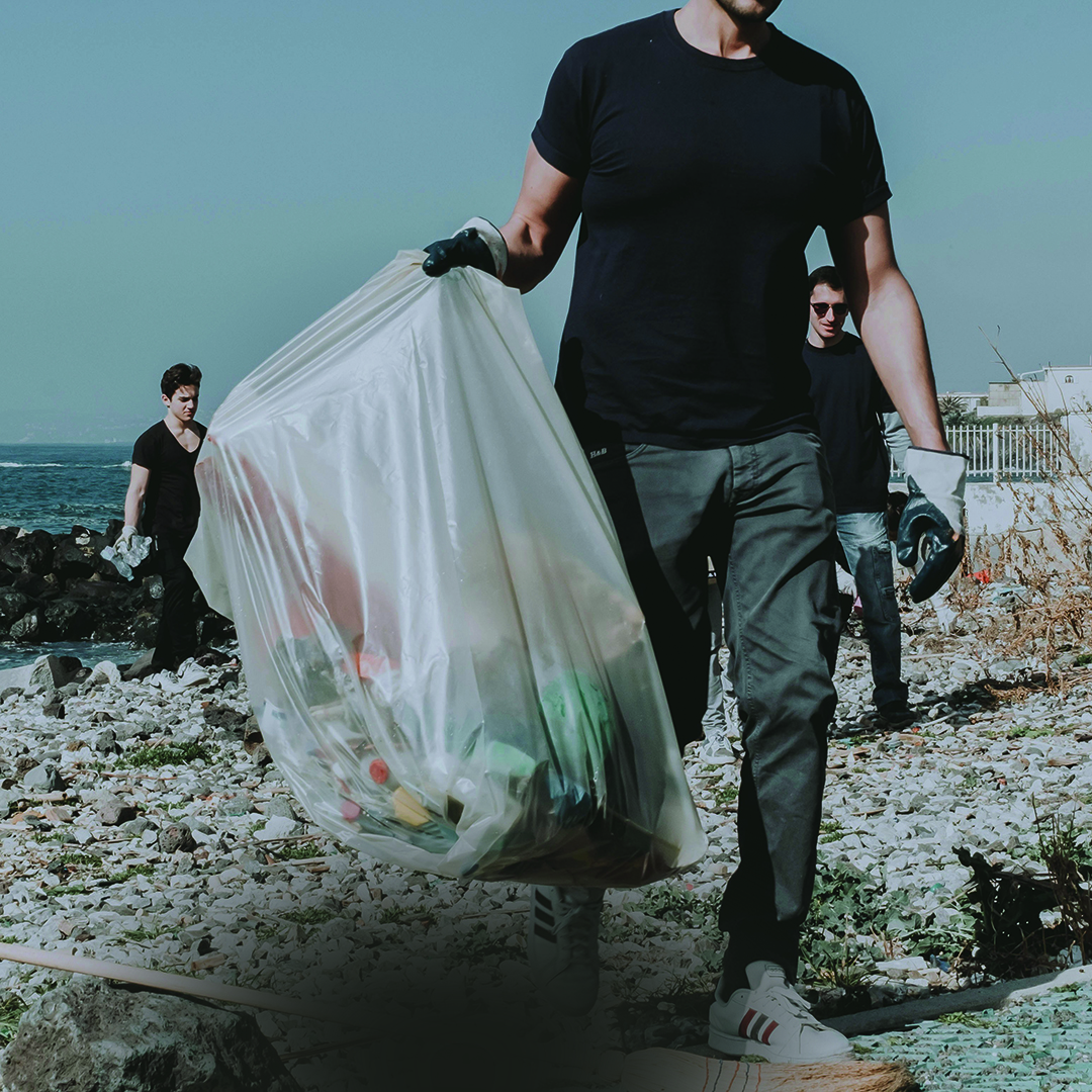 Person picking up rubbish outdoors