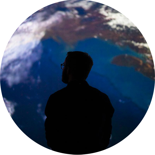 Silhouette of person, with image of earth in the background