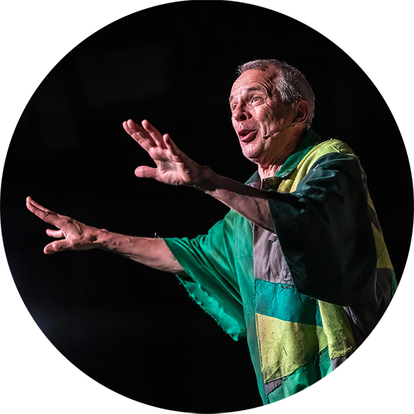 A person with two hands in front of them, they are conducting a talk and wearing a wireless microphone set.