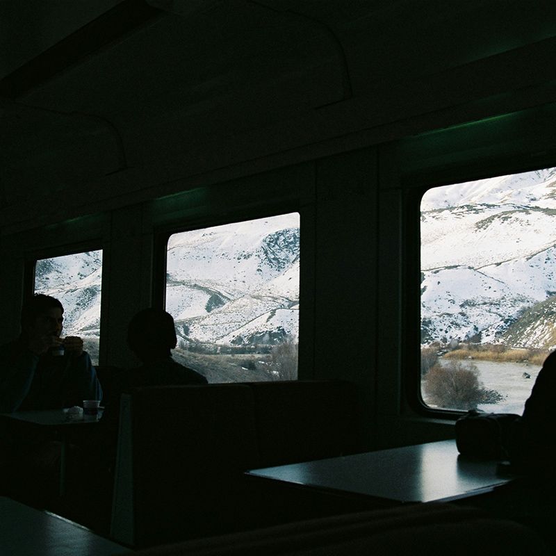 silhouette image in a train, can see the outside a snowy landscape